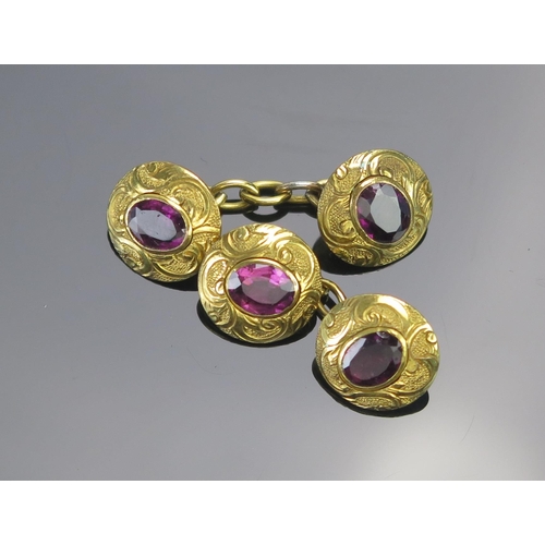 137 - A Pair of Antique Foil Backed Amethyst Cufflinks in a yellow metal setting with chased foliate decor... 