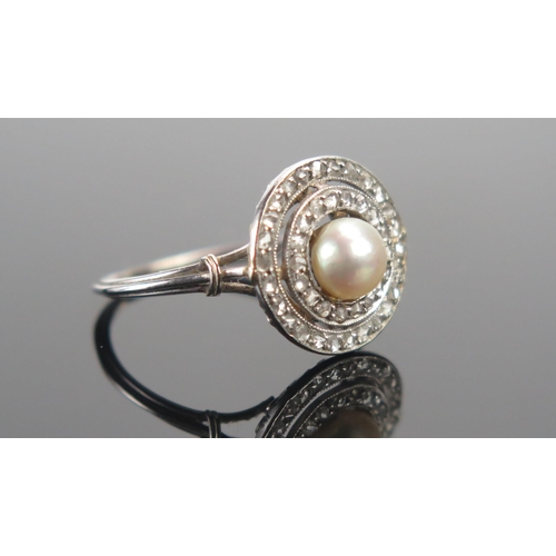 28 - An Antique Rose Cut Diamond and Pearl or Cultured Pearl Cluster Target Ring in a precious white meta... 