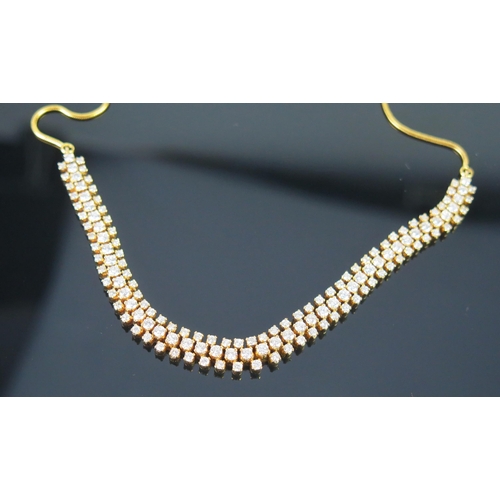 5 - A Diamond and Precious Yellow Metal Necklace set with 47 c. 2.65mm and 92 c. 2mm brilliant round cut... 