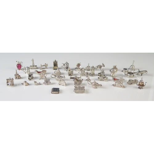 545 - A collection of white metal charms, including cars, church, lamp, flagons, churches, throne etc. tot... 