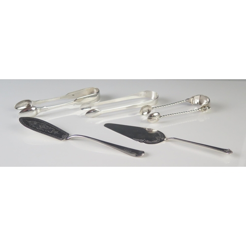 569 - Three pairs of silver sugar tongs and two slices, various makers and dates, total weight of silver 1... 