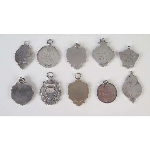 571 - A collection of ten silver fobs and sporting medallions, total weight of silver 103gms, 3.32ozs