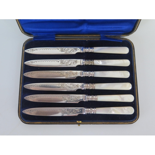 632 - A set of six silver plated and mother-of-pearl handled fruit knives, cased.