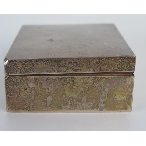 643 - A silver cigarette box, all marks worn and rubbed, of rectangular outline with engine turned decorat... 