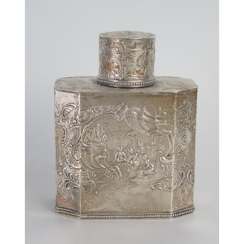 672 - A Dutch silver tea caddy, and cover, stamped marks, with embossed decoration of figures with in flow... 