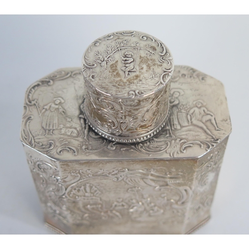 672 - A Dutch silver tea caddy, and cover, stamped marks, with embossed decoration of figures with in flow... 