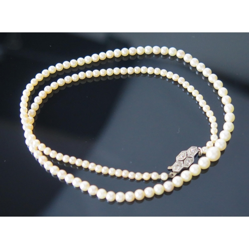 7 - A Single Strand Graduated Pearl or Cultured Pearl Necklace with a precious white metal and old cut d... 