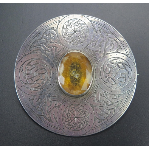 74 - Precious White Metal Shield Brooch with chased decoration and paste centre33.28g, 59.4mm diam.