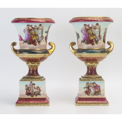 1013 - A pair of Vienna style porcelain vases, decorated with neoclassical maidens and attendants, with scr... 