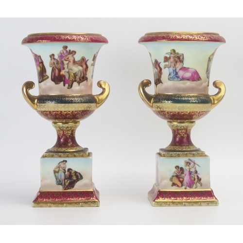 1013 - A pair of Vienna style porcelain vases, decorated with neoclassical maidens and attendants, with scr... 