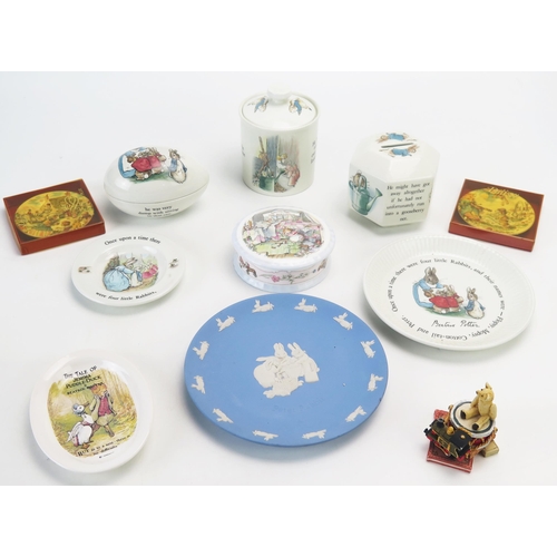 1018 - A collection of Wedgwood Beatrix Potter wares including money box, nursery plates, trinket egg etc.