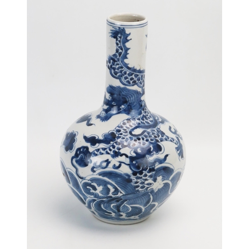 1024 - A Chinese blue and white bottle vase, decorated with dragon, and fish,  bears Qianlong style charact... 