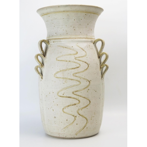 1034 - Carol Harlow a studio pottery vase of large size, with three scrolling handles and incised wavy stri... 