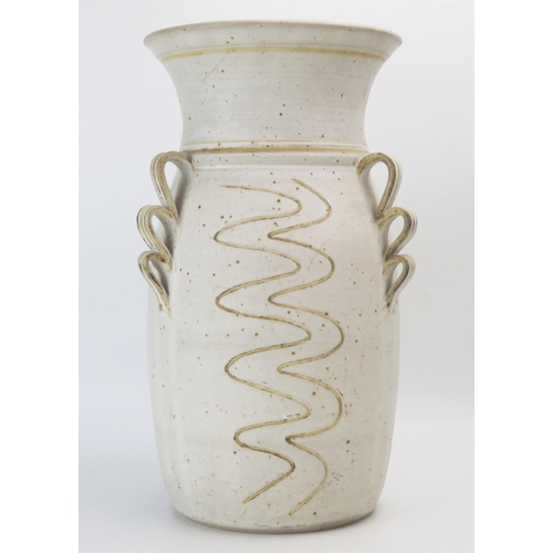 1034 - Carol Harlow a studio pottery vase of large size, with three scrolling handles and incised wavy stri... 