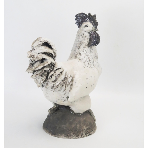 1049 - A large Raku cockerel, raised on a dome base, 29cm high.