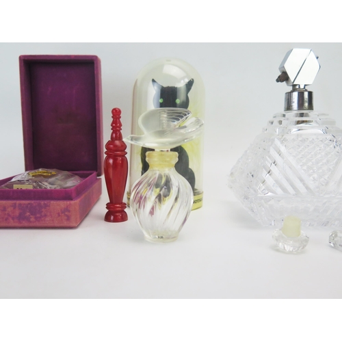 1058 - A collection of assorted glass and other scent bottles including Lalique and others.