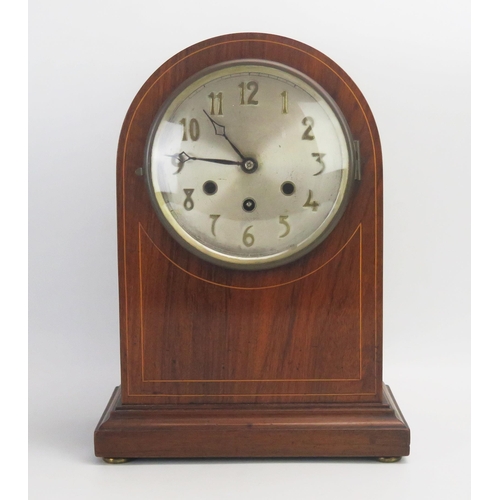 1067 - A mahogany and boxwood strung mantel clock, of arched outline, with 16cm silvered Arabic dial, the m... 