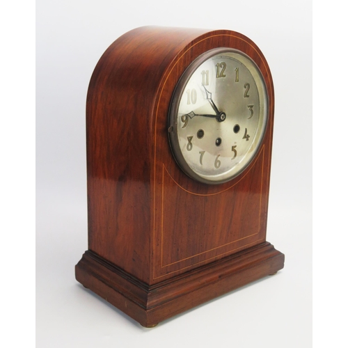 1067 - A mahogany and boxwood strung mantel clock, of arched outline, with 16cm silvered Arabic dial, the m... 