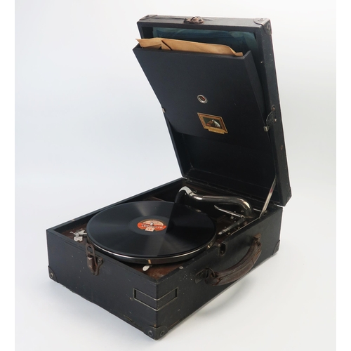 1076 - An HMV picnic gramophone, fitted with a winding handle. hinged needle holder, with three 78RPM recor... 