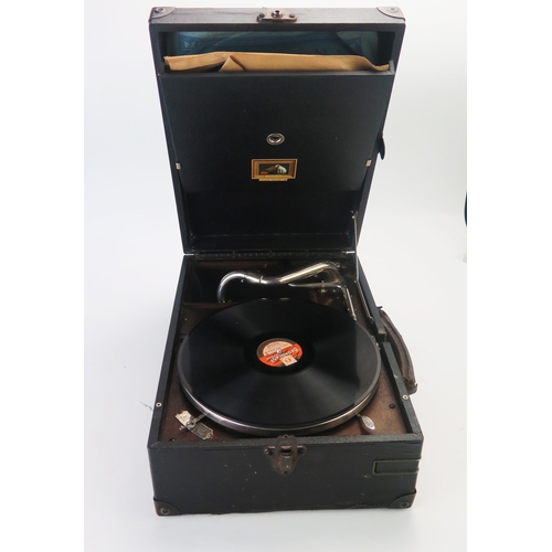 1076 - An HMV picnic gramophone, fitted with a winding handle. hinged needle holder, with three 78RPM recor... 