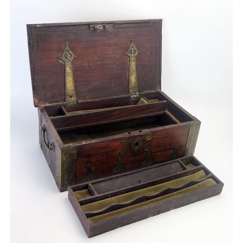 1088A - A middle eastern hardwood and brass mounted scribes box, of rectangular outline, the hinged lid encl... 