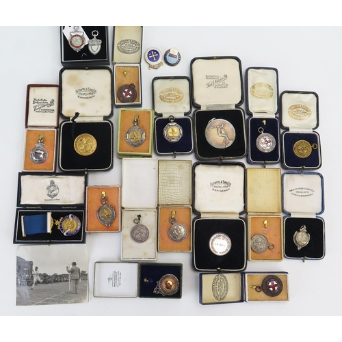 1098 - A collection of silver and other sports and athletic medallions, various makers and dates, weighable... 