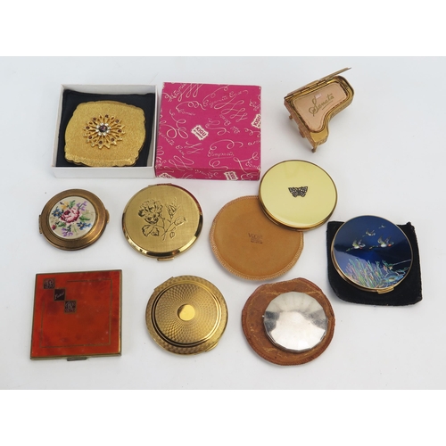 1109 - A collection of assorted ladies compacts, including boxed example, another in the form of a piano,