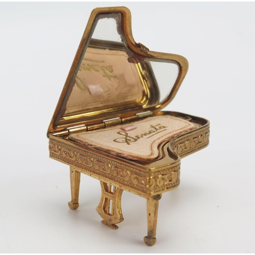 1109 - A collection of assorted ladies compacts, including boxed example, another in the form of a piano,