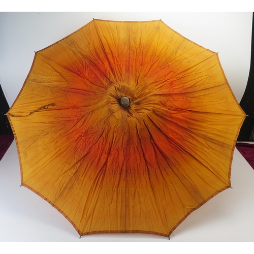 1118 - An early 20th century parasol, with orange silk canopy.