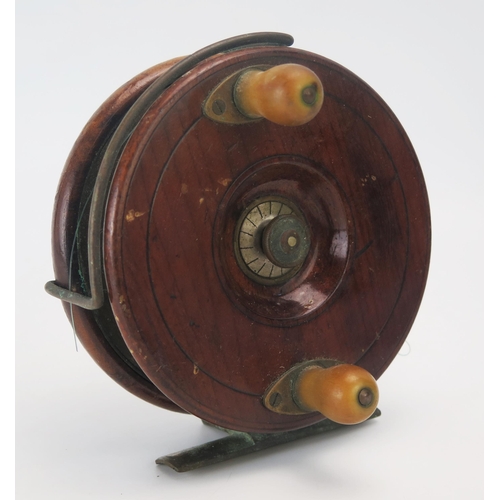 1132 - A mahogany and brass starback sea fishing reel, with 5 inch solid drum, tension screw, check button,... 