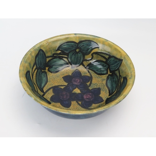 1150 - A Morris ware pottery fruit bowl, with floral decoration to the interior, 26.5cm diameter.