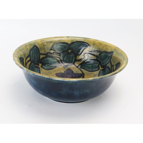 1150 - A Morris ware pottery fruit bowl, with floral decoration to the interior, 26.5cm diameter.