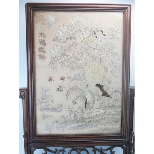 1165A - A Chinese carved hardwood table top screen, with rectangular silk work panel depicting exotic birds ... 