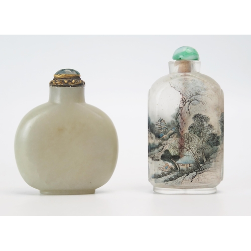 1166 - A Chinese clear glass and interior decorated scent bottle, 7.5cm high, together with a jadeite scent... 