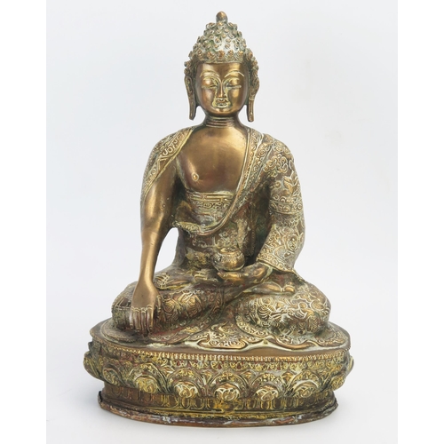 1169 - A Large gilt brass figure of Buddha, seated crossed legged on a lotus flower, 32cm high.