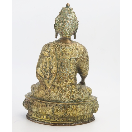 1169 - A Large gilt brass figure of Buddha, seated crossed legged on a lotus flower, 32cm high.