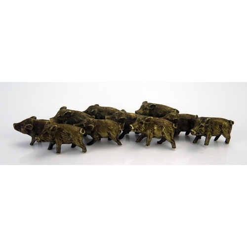 1185 - A bronze model of a group of wild boar,  unsigned, 14cm.