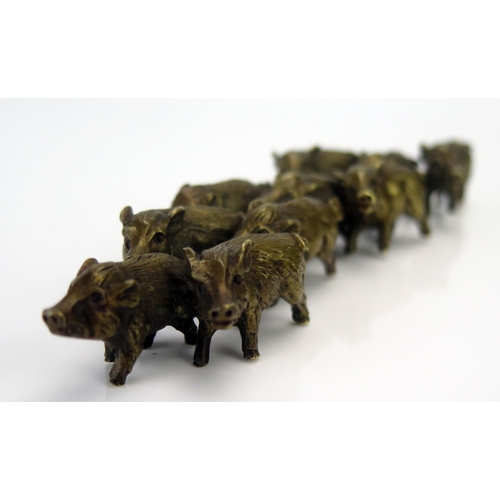 1185 - A bronze model of a group of wild boar,  unsigned, 14cm.