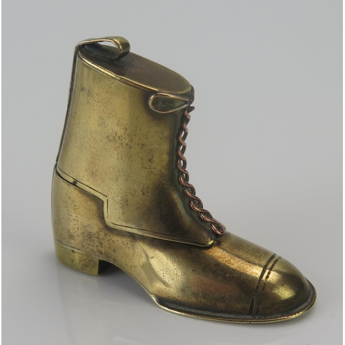 1187 - A novelty cigarette lighter in the form of a gaitered boot, 4.5cm high.