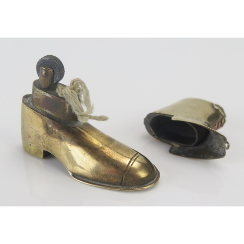 1187 - A novelty cigarette lighter in the form of a gaitered boot, 4.5cm high.