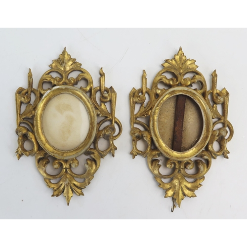 1192 - A pair of Florentine gilt wood oval frames, with foliate crests and scroll decoration.15cm high,