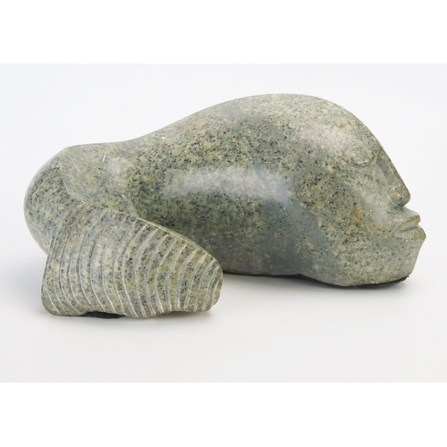 1194 - J Mura, a carved hardstone abstract fish with human face, signed J Mura, 28cm wide,