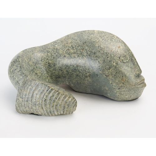 1194 - J Mura, a carved hardstone abstract fish with human face, signed J Mura, 28cm wide,