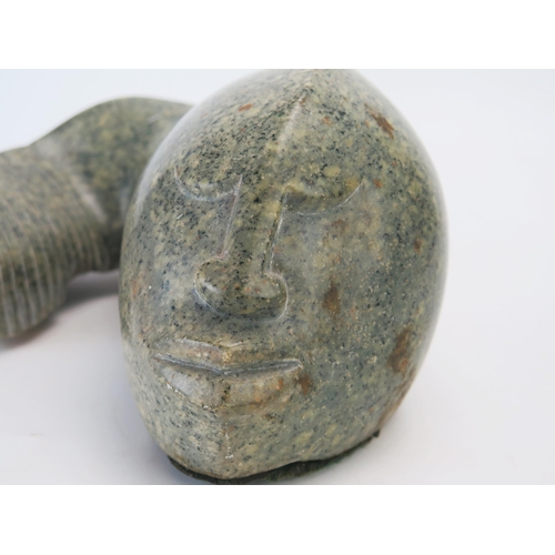 1194 - J Mura, a carved hardstone abstract fish with human face, signed J Mura, 28cm wide,