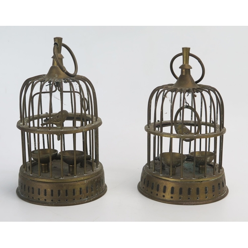 1273 - Two brass models of caged birds, 22cm high.