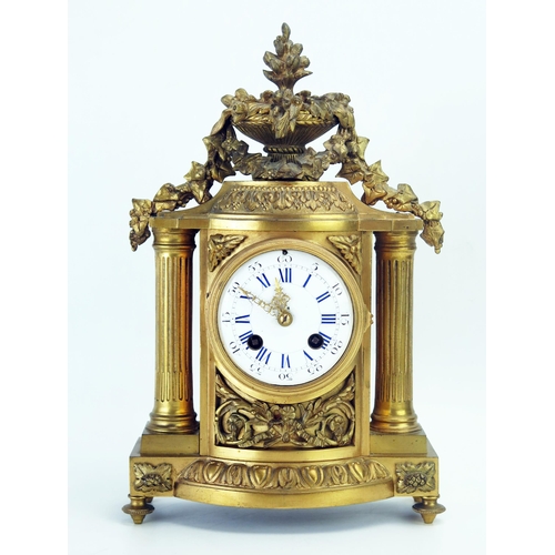 1279 - A late 19th century gilt metal mantel clock, of arched outline surmounted with a vase of flowers and... 