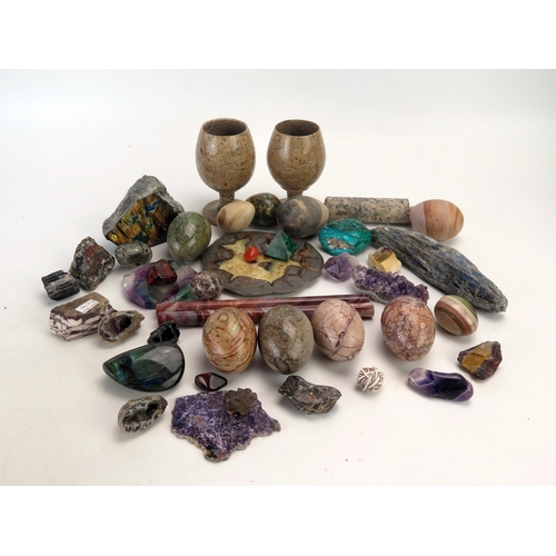 1284 - A collection of polished stone goblets, geode slices, polished stone eggs, and geological specimens.