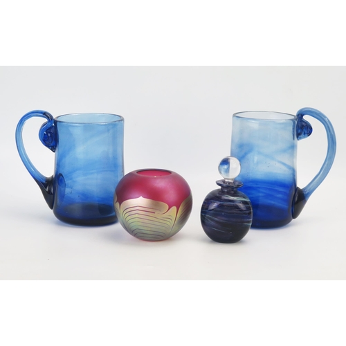 1295 - A pair of variegated blue glass mugs, 17.5cm high, a glass scent bottle and a purple glass vase, sig... 