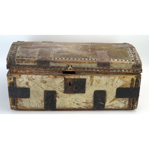 1310 - A hide and metal mounted domed travelling trunk, with loop carrying handles to the sides, 56cm wide