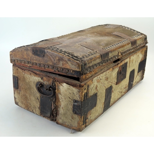 1310 - A hide and metal mounted domed travelling trunk, with loop carrying handles to the sides, 56cm wide